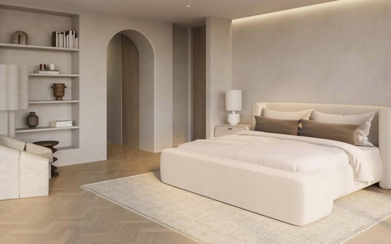 Soothing Organic Modern bedroom with arched plaster opening, light wood floors, built-in wall shelves, and layered neutral textures.