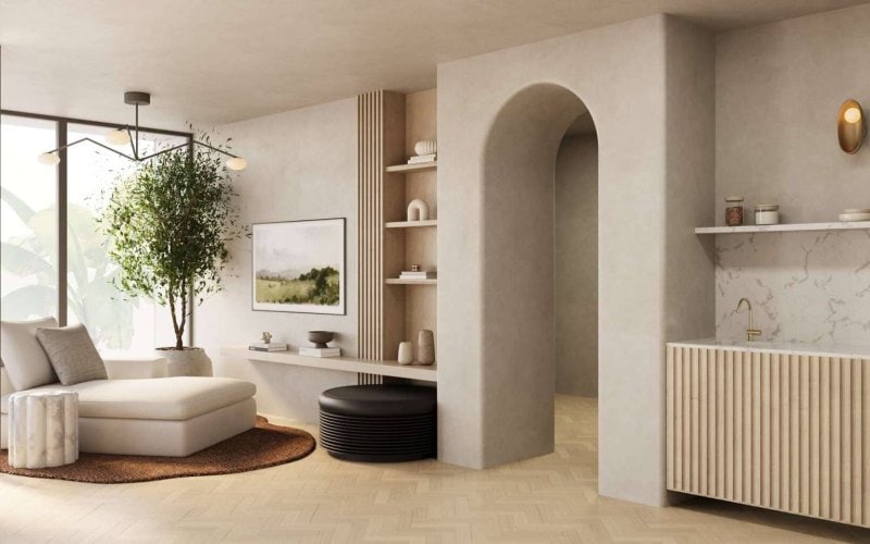 Refined Organic Modern lounge with arched doorway, slatted bar cabinetry, custom shelving, and a cozy chaise by floor-to-ceiling windows.