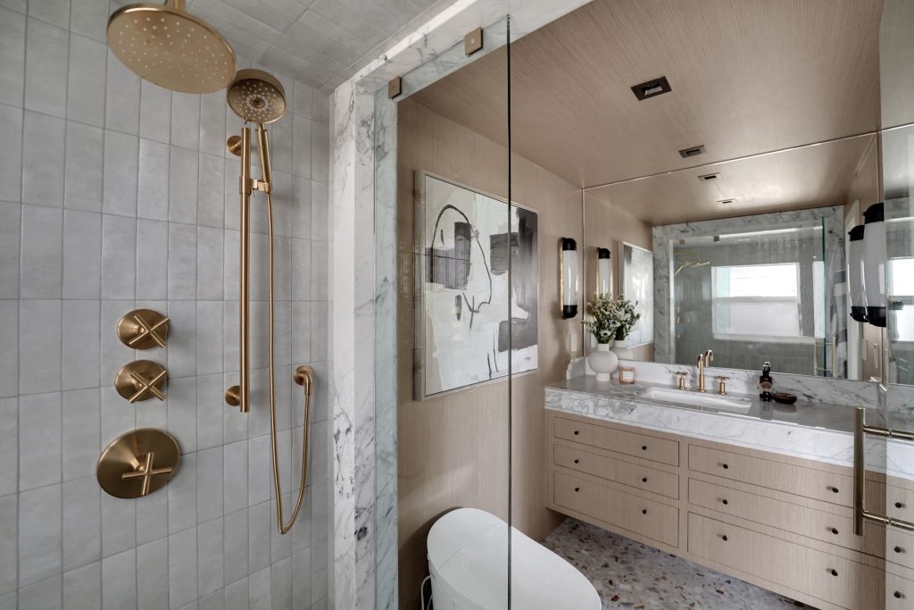 Bathroom with custom marble vanity, cappuccino veneer, and frameless shower. in Harbor Beach, Fort Lauderdale | Modern Coastal design