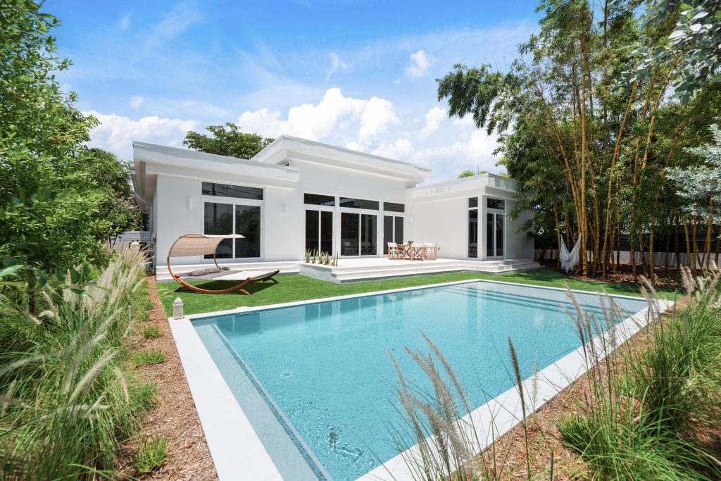 42-Rear facade of modern coastal home with pool, bamboo landscaping, and porcelain pavers in Wilton Manors.