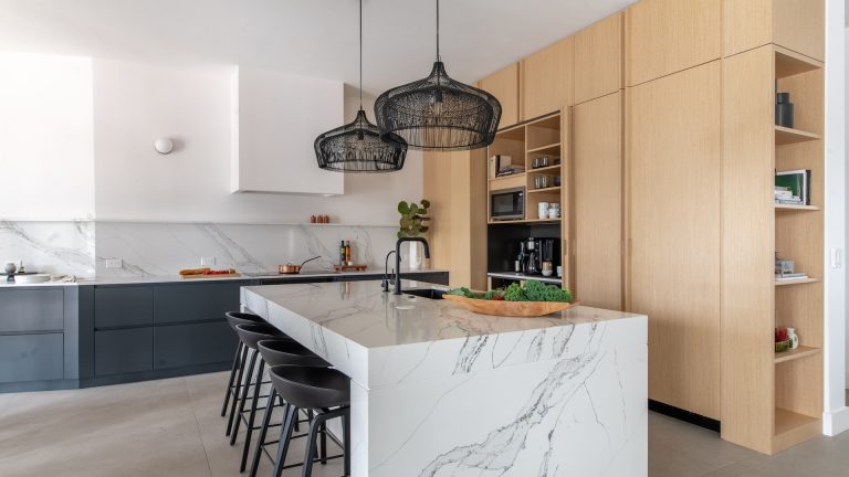 Fort Lauderdale waterfront organic modern kitchen with white marble island, custom oak cabinetry & concealed appliances by STUDIO 818